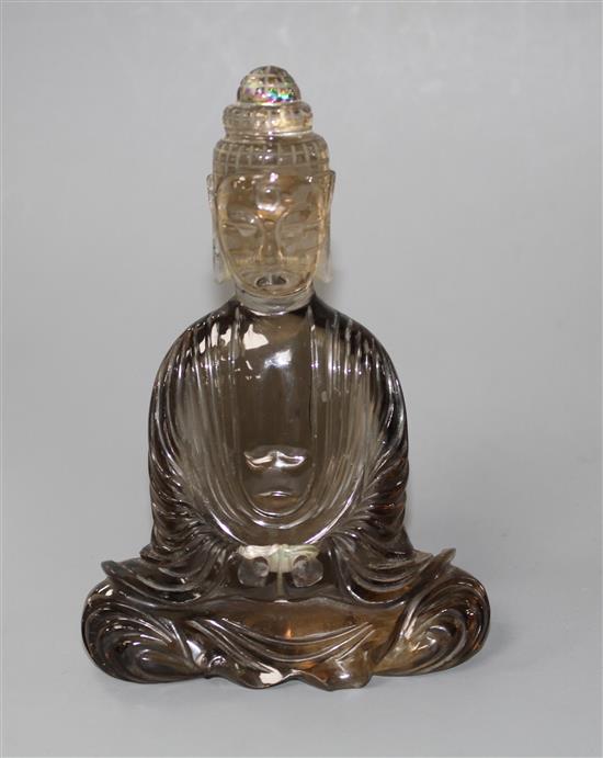 A Chinese smoky quartz seated figure of Guanyin, 19th/early 20th century, H. 11.5cm